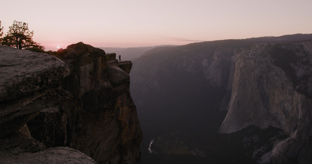 Couple standing on Taft Point above Yosemite Valley